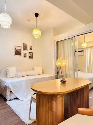 a room with a bed and a table in it at The K-Butter Lounge by Kozy Mood near BGC in Manila