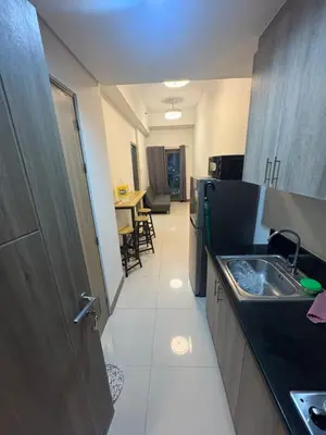a small kitchen with a sink and a table at S Residences pool side 3 in Manila