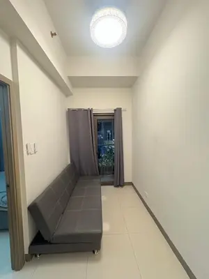 a empty room with a couch in a room at S Residences pool side 3 in Manila
