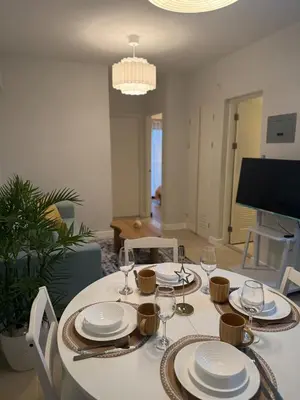 a dining room table with plates and wine glasses at Stylish Cozy Nordic 2BR Netflix & Free Parking in Manila