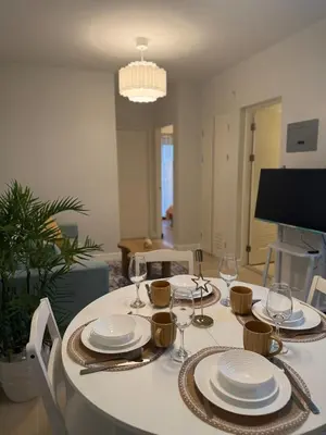 a dining table with plates and wine glasses on it at Stylish Cozy Nordic 2BR Netflix & Free Parking in Manila