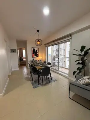 a dining room with a table and a large window at Spacious 3BR Sucat Netflix and Free Parking in Manila