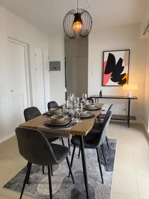 a dining room with a table and chairs at Spacious 3BR Sucat Netflix and Free Parking in Manila