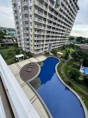an aerial view of a large apartment building with a pool at Spacious 3BR Sucat Netflix and Free Parking in Manila