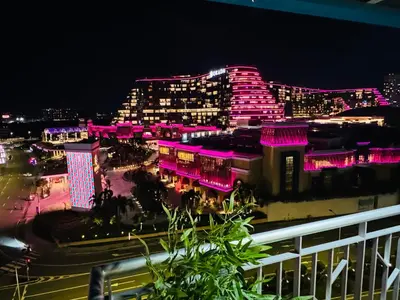 a view of a city at night with pink lights at High-Floor Stay near Okada, Airport, City of Dreams, Solaire and MOA with free pool and gym access in Manila