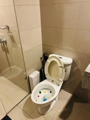 a bathroom with a toilet with the seat up at High-Floor Stay near Okada, Airport, City of Dreams, Solaire and MOA with free pool and gym access in Manila