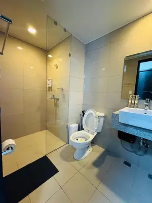 a bathroom with a toilet and a shower and a sink at High-Floor Stay near Okada, Airport, City of Dreams, Solaire and MOA with free pool and gym access in Manila