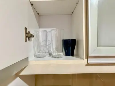 three glass vases sitting on a shelf in a kitchen at Aesthetic Modern Suite 1BR One Uptown Residence BGC in Manila
