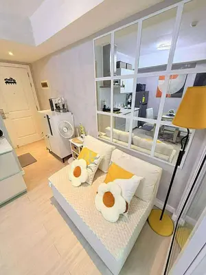 a living room with a couch with pillows at Condotels Villa Topaz in Manila