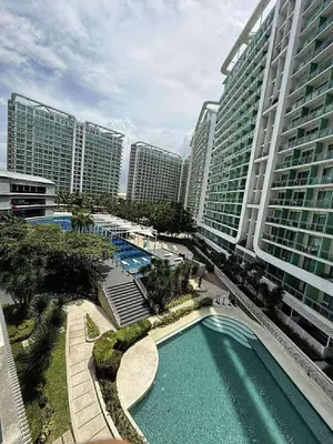 an overhead view of a pool in a city with tall buildings at Condotels Villa Topaz in Manila