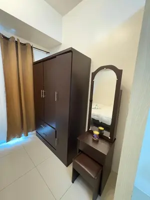 a bathroom with a vanity and a mirror at Jazz Residences in Manila