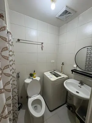 a small bathroom with a toilet and a sink at Jazz Residences in Manila