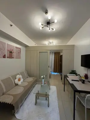 a living room with a couch and a table at Jazz Residences in Manila