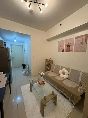 a living room with a couch and a table at Jazz Residences in Manila