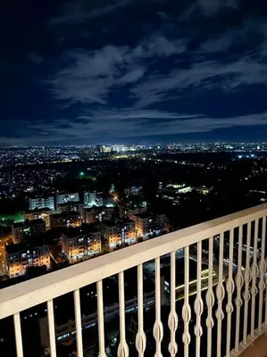 a view of a city at night from a balcony at 29H Ultimate Esports Studio Massage Chair Pro Setup in Manila