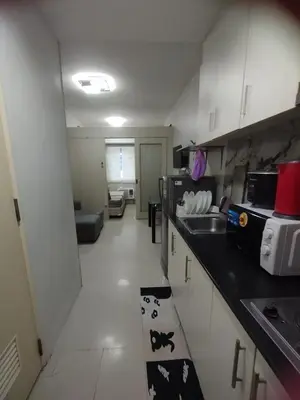 a kitchen with a sink and a counter top at Sea Residences MOA Area in Pasay City in Manila