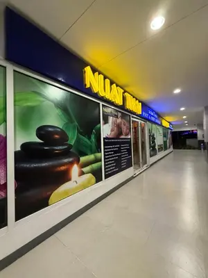 a hallway of a mall with signs on the wall at Sea Residences MOA Area in Pasay City in Manila