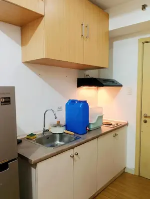 a kitchen with a sink and a counter top at Penguin Hotel in Manila
