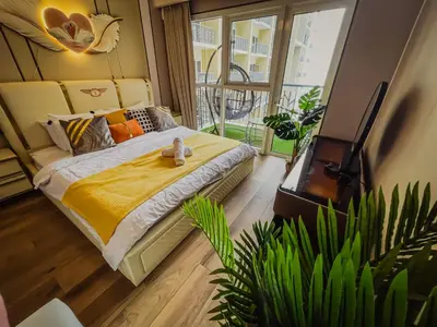 a bedroom with a bed with a yellow blanket at Spacious & Luxury 4BR Home across Okada and Solaire in Manila
