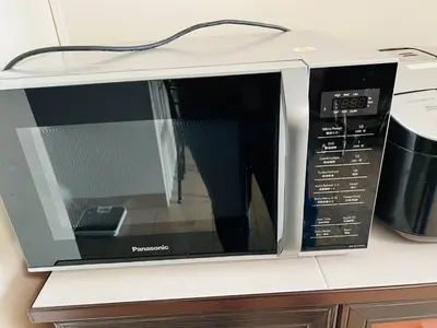 a microwave oven sitting on top of a counter at Cozy BB in the Heart of Quezon City in Manila