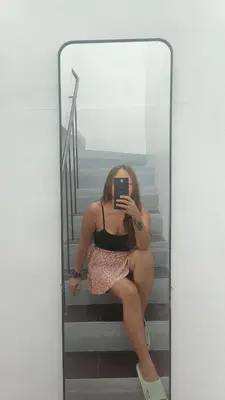 a woman sitting on the stairs taking a picture in a mirror at Islana Stay for Family of 3 in Gen Trias Cavite in General Trias