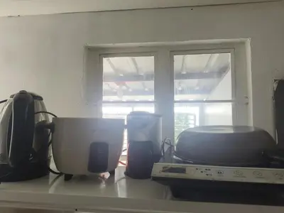 a kitchen counter with a microwave and a window at Islana Stay for Family of 3 in Gen Trias Cavite in General Trias