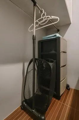 a black vacuum sitting next to a computer monitor at Islana Stay for Family of 3 in Gen Trias Cavite in General Trias