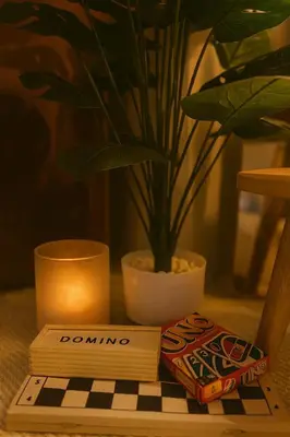 a book on a table with a candle and a potted plant at Islana Stay for Family of 3 in Gen Trias Cavite in General Trias