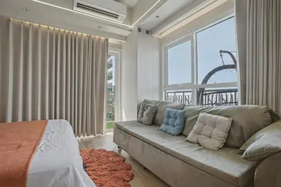 a living room with a couch and a large window at Elegant and Spacious 3BR Home near Okada, Solaire in Manila