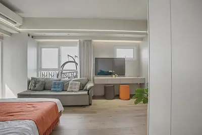 a bedroom with a couch and a tv in it at Elegant and Spacious 3BR Home near Okada, Solaire in Manila