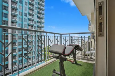 a treadmill on a balcony with a view of a building at Elegant and Spacious 3BR Home near Okada, Solaire in Manila