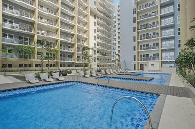 a swimming pool in front of some apartment buildings at Elegant and Spacious 3BR Home near Okada, Solaire in Manila