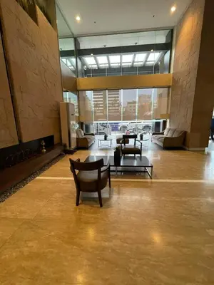 a lobby with chairs and tables in a building at Antel Spa Residences 1703 in Manila