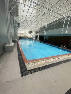 a large swimming pool in a large building at Antel Spa Residences 1703 in Manila