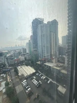 a view of a city with cars parked in a parking lot at Antel Spa Residences 1703 in Manila
