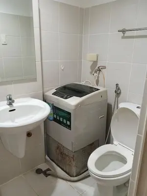 a small bathroom with a toilet and a sink at Rosaland staycation in Manila