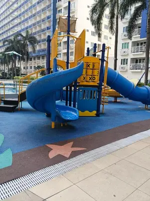 a playground with a slide in a park at Rosaland staycation in Manila