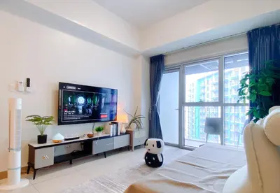a bedroom with a tv and a large window at 120SQM 3Bedrooms with Balcony Facing Infinity Pool Manila Bay Sunset, Near Airports, OKADA, Solaire, MOA with Free Parking in Manila