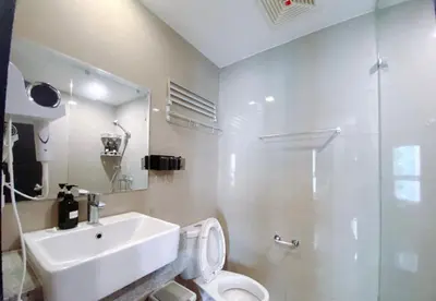 a bathroom with a sink and a toilet and a shower at 120SQM 3Bedrooms with Balcony Facing Infinity Pool Manila Bay Sunset, Near Airports, OKADA, Solaire, MOA with Free Parking in Manila