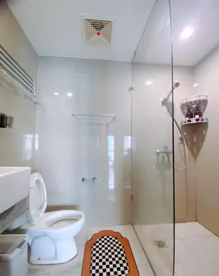a bathroom with a toilet and a glass shower at 120SQM 3Bedrooms with Balcony Facing Infinity Pool Manila Bay Sunset, Near Airports, OKADA, Solaire, MOA with Free Parking in Manila