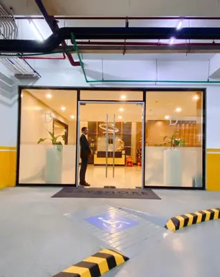 a man standing in front of a store window at 120SQM 3Bedrooms with Balcony Facing Infinity Pool Manila Bay Sunset, Near Airports, OKADA, Solaire, MOA with Free Parking in Manila
