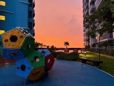 a sculpture in a park with a sunset in the background at 120SQM 3Bedrooms with Balcony Facing Infinity Pool Manila Bay Sunset, Near Airports, OKADA, Solaire, MOA with Free Parking in Manila