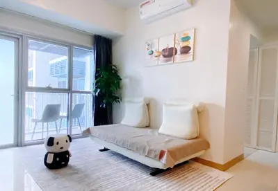 a living room with a couch and a large window at 120SQM 3Bedrooms with Balcony Facing Infinity Pool Manila Bay Sunset, Near Airports, OKADA, Solaire, MOA with Free Parking in Manila