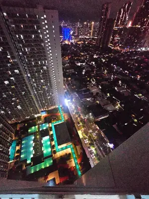 an aerial view of a city at night at Nest & Rest by RanDecz in Manila