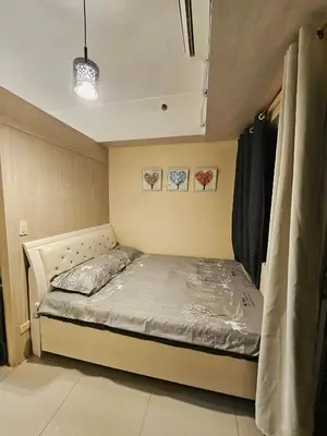 a small bedroom with a bed in a room at Nest & Rest by RanDecz in Manila