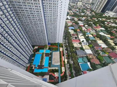 an aerial view of a city with a tall building at Nest & Rest by RanDecz in Manila