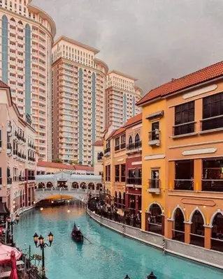 a river with boats in a city with tall buildings at Stamford Executive Residences, McKinley Hill in Manila