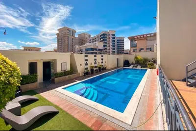 a swimming pool on the balcony of a building at Stamford Executive Residences, McKinley Hill in Manila