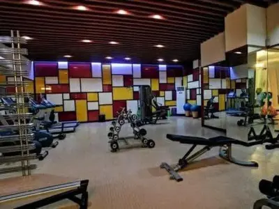 a gym with several exercise equipment in a room at Stamford Executive Residences, McKinley Hill in Manila