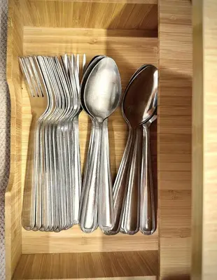a wooden box with silver utensils in it at Cozy Modern Condo in Little Baguio Terraces San Juan City in Manila